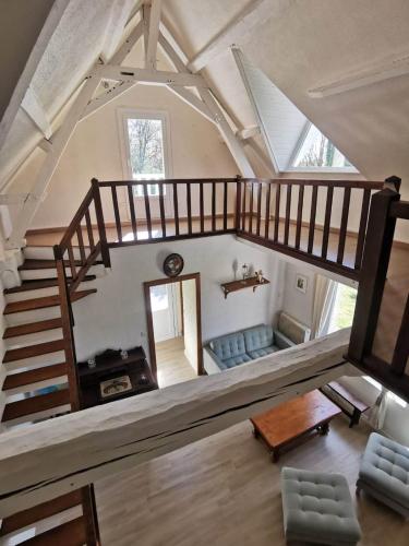 an overhead view of a living room with a staircase at Chez Pierre Et Deme in Saint-Jacques-des-Guérêts