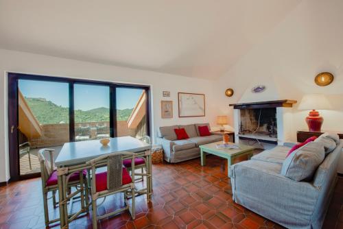 a living room with a couch and a fireplace at Porto Ercole Maison vista mare in Cala Galera