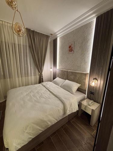 a bedroom with a white bed and a window at Gold Palace Hotel in Cairo