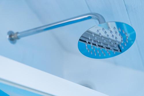 a shower head in a bathroom with a blue at Dimora Zagara in Amalfi