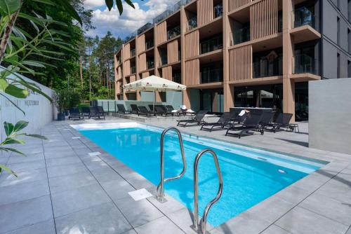 a swimming pool in front of a building at Eden Sea in Międzyzdroje