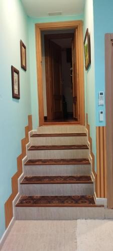 a set of stairs in a building with a door at Pensión CASA LEÓN in Santoña