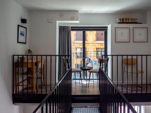 a balcony with a table and chairs in a room at Apartments Central Madrid - q2home in Madrid
