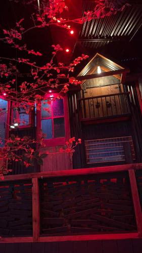 a building with red lights and a tree at La Blanca Hotel in Viña del Mar