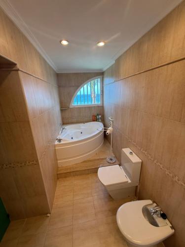 a bathroom with a toilet and a bath tub at Akimaria Residence in Oropesa del Mar