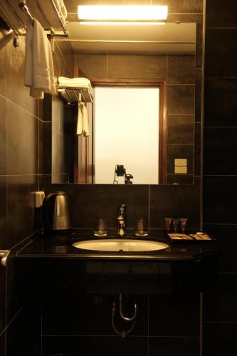 a bathroom with a sink and a mirror at Moc Hoang Hotel in Hanoi