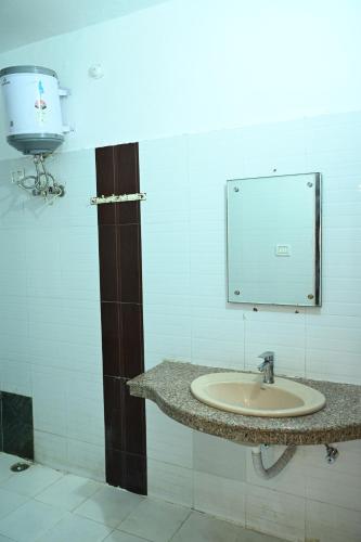 a bathroom with a sink and a mirror at Happpy Stay in Lucknow