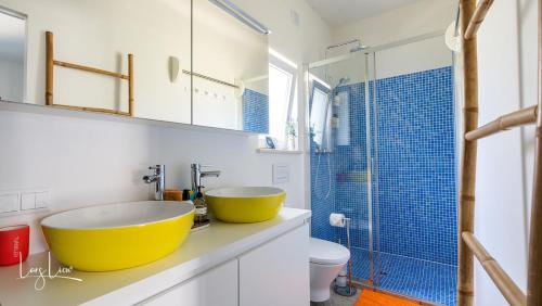 a bathroom with a large yellow bowl sink on a counter at Seeds of Silence boutique wellbeing hotel near Olhao Faro in Olhão