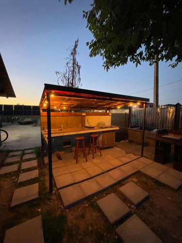 a backyard with a shed with a table and stools at 317 Accommodation in Ucea de Sus