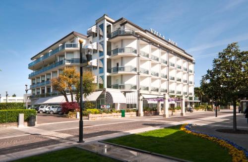 an apartment building on a street in front of a building at Terme Villa Pace in Abano Terme