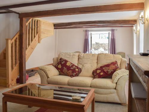 a living room with a couch and a table at Woodlands in Laugharne