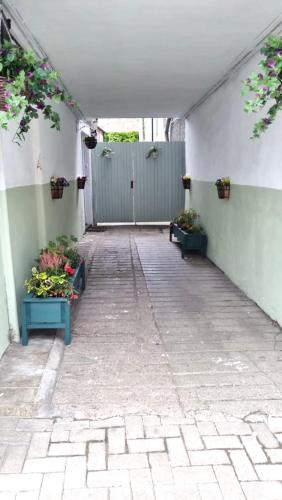 an empty hallway with two potted plants in a building at The Canongate Coorie in Jedburgh