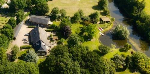 an aerial view of a large building next to a river at Landgoed Wittelte Dwingeloo in Wittelte
