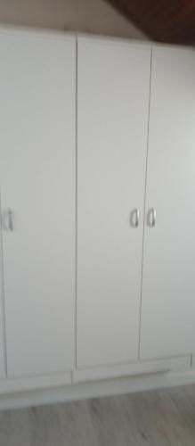 a row of white cabinets in a room at Apartman Vesna in Igalo