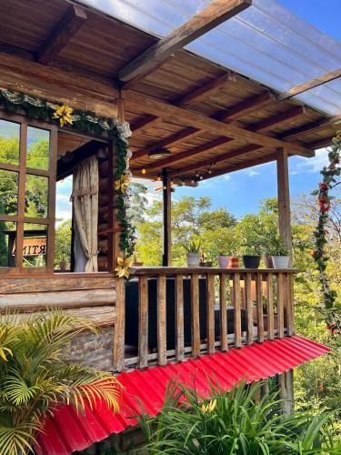 a porch of a house with a wooden deck at Cabaña La Martina in Santa Rosa de Cabal