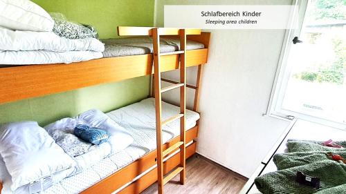 a bunk bed room with two bunk beds at Talblick 1 - Ihr Ferienhaus mitten im idyllischen Tal in Bad Bibra