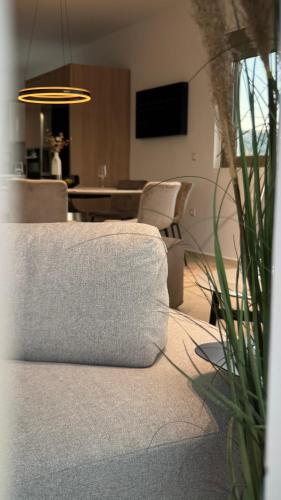 a living room with a couch and a table and chairs at ARYVE Boutique Villa mit Akropolis- und Meerblick, Infinity-Pool und Designer-Interieur in Malona Village