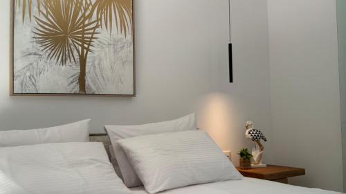 a bedroom with two white pillows on a bed at ARYVE Boutique Villa mit Akropolis- und Meerblick, Infinity-Pool und Designer-Interieur in Malona Village