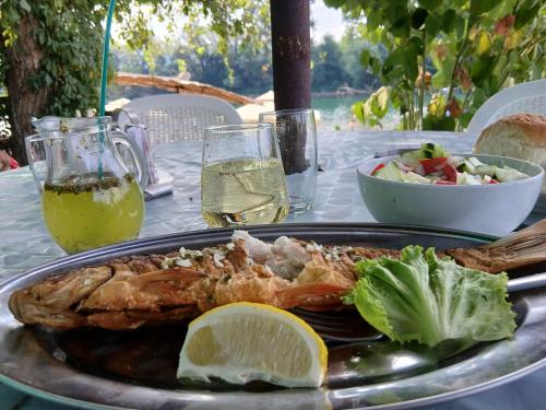 a plate of food with a shrimp on a table at Tri srca in Banja Koviljača