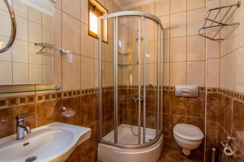 a bathroom with a toilet, sink and tub at Magic Tulip Beach Hotel in Oludeniz