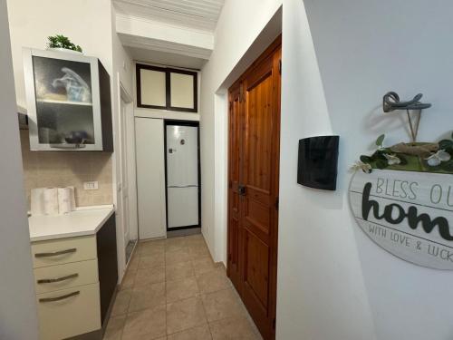 a bathroom with a sink and a door with a sign at rupea breeze home in Tropea