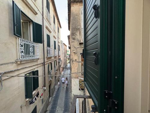 two people walking down an alley between two buildings at rupea breeze home in Tropea