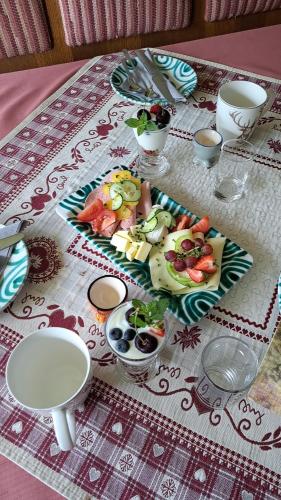 a table with a plate of food on a table at Urlaub am Liasnhof in Bad Aussee