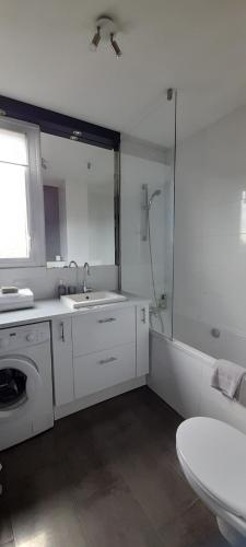 a white bathroom with a sink and a shower at Type 2 Catho Esa in Angers