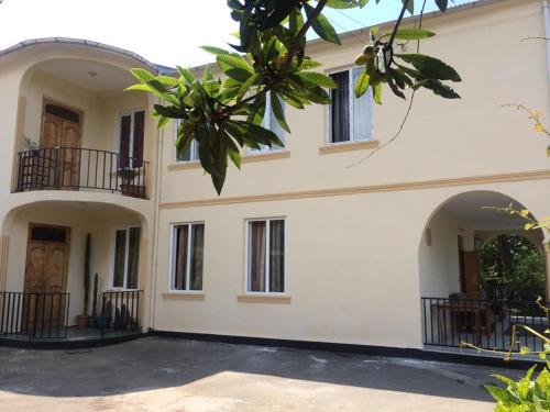 a large house with two balconies on it at Talo's Guest House in Makhinjauri