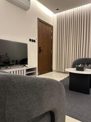 a living room with a couch and a table at dana hotel apartments in Taif