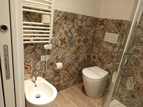 a bathroom with a toilet and a shower at Hotel Acquario in Genova