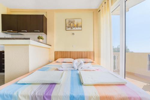 a bedroom with two beds with towels on them at Apartment Dragicevic 5 with Garage in Budva