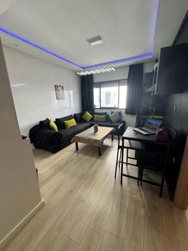 a living room with a couch and a table at Studio pas cher au parc in Mohammedia
