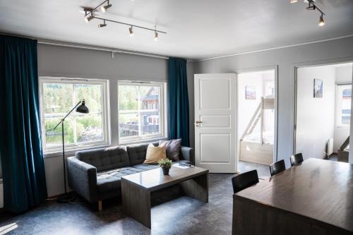 a living room with a couch and a table at Hemsedal Cafe Skiers Lodge in Hemsedal