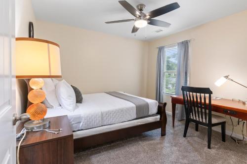 a bedroom with a bed and a desk with a computer at 5BR Oasis with 3 Spa-Like Baths in Riverdale
