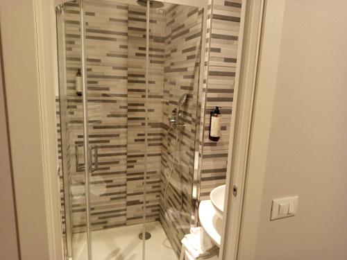a glass shower in a bathroom with a toilet at Hotel Acquario in Genova