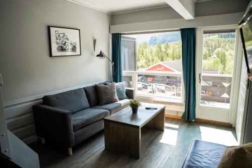 a living room with a couch and a table at Hemsedal Cafe Skiers Lodge in Hemsedal