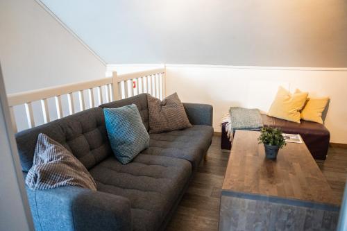 a living room with a couch and a coffee table at Hemsedal Cafe Skiers Lodge in Hemsedal