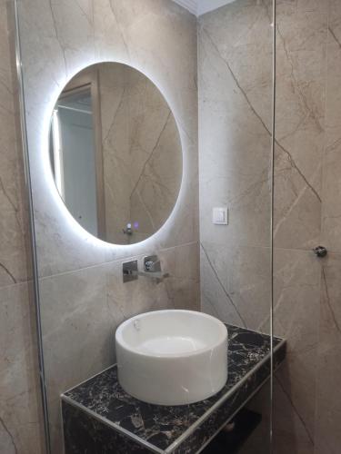 a bathroom with a sink and a mirror at EriZen Jacuzzi suites in Keramotí