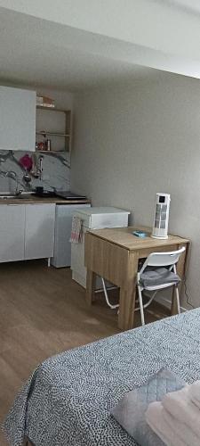 a room with a kitchen and a table with a laptop at Affittacamere Pratello 97 in Bologna