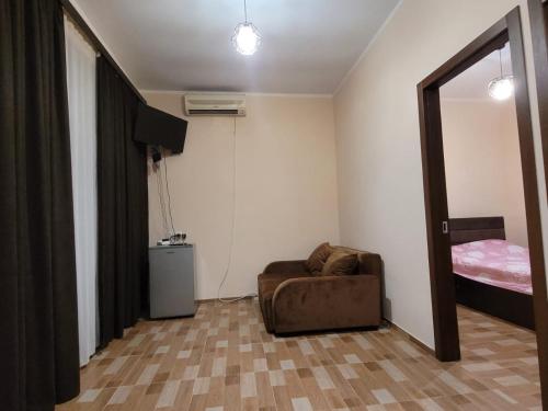a living room with a couch and a bed at Shekvetili - Kaprovani, Georgia in Shekvetili