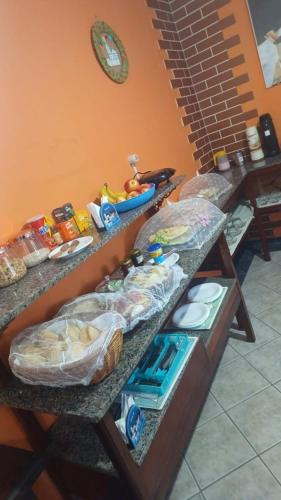 two counter tops with food on them in a kitchen at Pousada Vila das Artes in Paraty