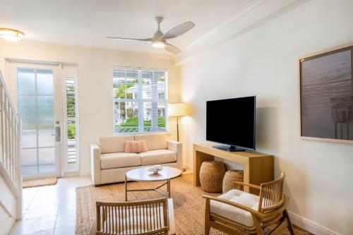 a living room with a couch and a tv at Bayside Villas by Islander Resort in Islamorada