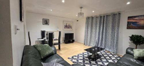 a living room with a couch and a television at E13 x DM4 weekly monthly deals in London
