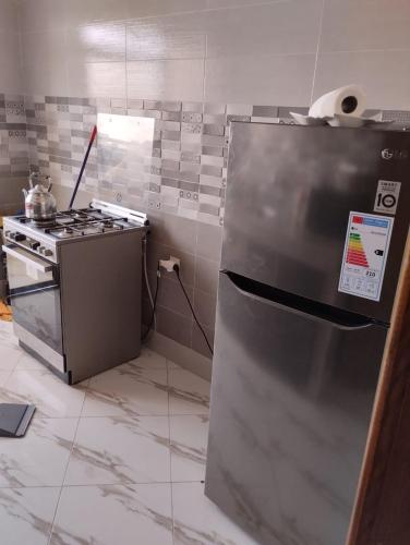 a kitchen with a stainless steel refrigerator and a stove at Settat, Morocco in Settat