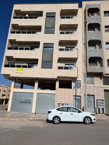 a white car parked in front of a building at Settat, Morocco in Settat