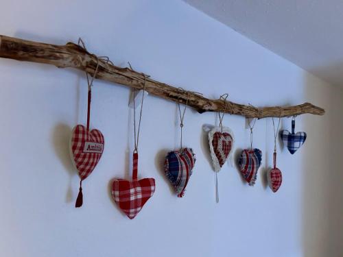 a group of hearts hanging on a wall at Gîte " le Schmoutzi" Duplex centre historique Riquewihr in Riquewihr
