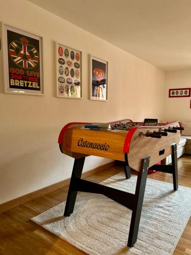 a ping pong table sitting on top of a rug at Gîte " le Schmoutzi" Duplex centre historique Riquewihr in Riquewihr