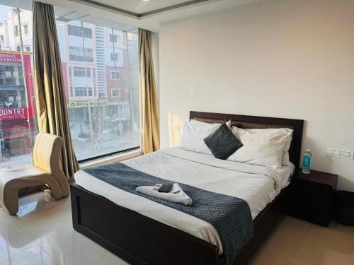 a bedroom with a bed with a pair of shoes on it at Wild Wings Hotel in Hyderabad
