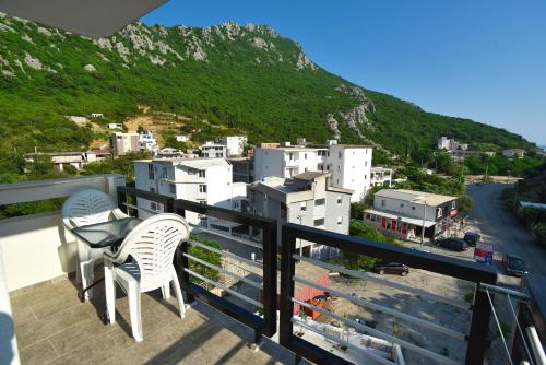 a balcony with two chairs and a view of a city at Apartments A Čanj in Čanj